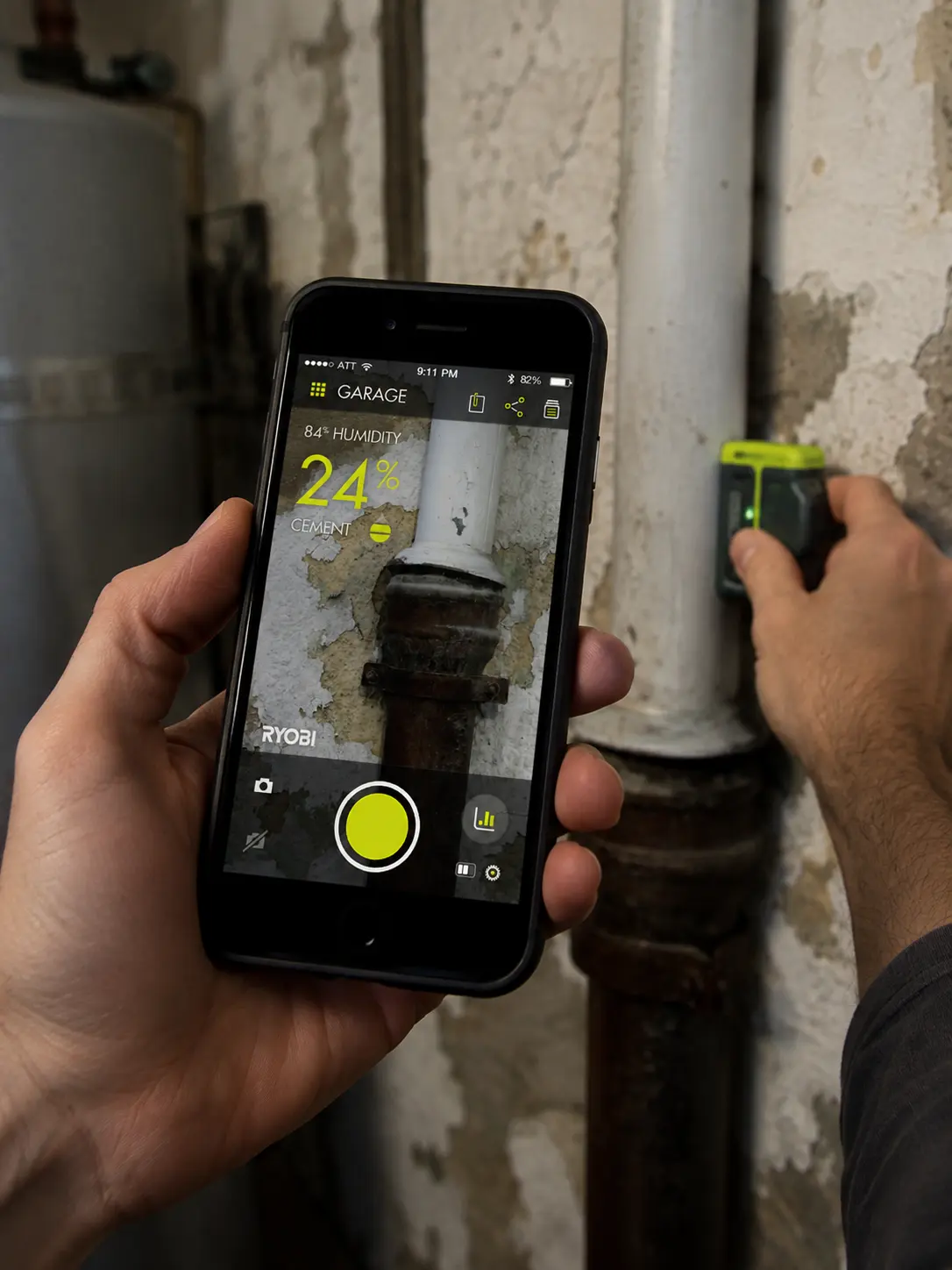 The moisture meter reads cement at 24 percent, shown against the room's 84 percent humidity so the number means something.