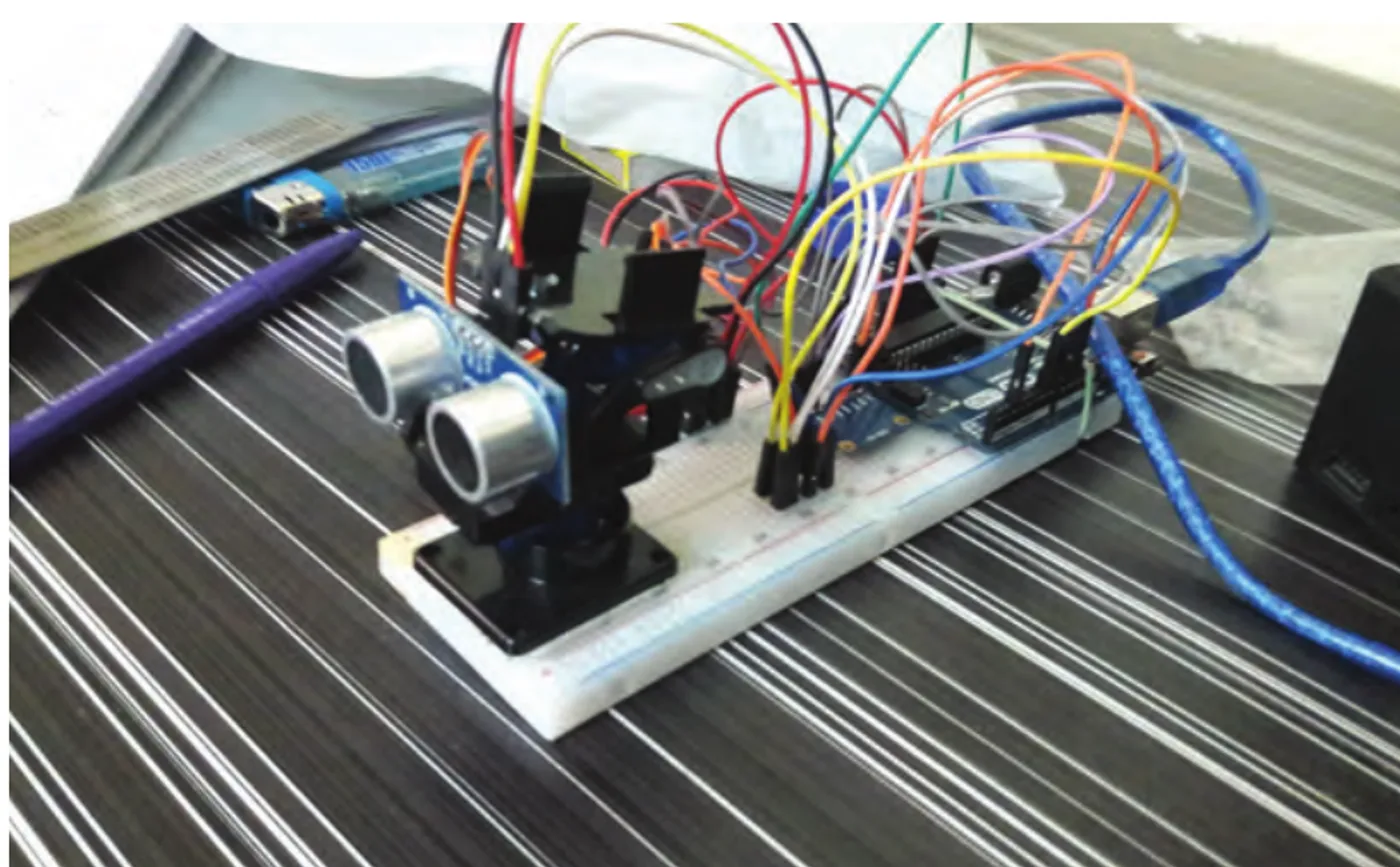 The Lead breadboard prototype, an ultrasonic sensor on a tilt mount wired to an Arduino